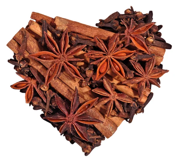 Star anise, cinnamon sticks and cloves in the form of heart on a — Stock Photo, Image