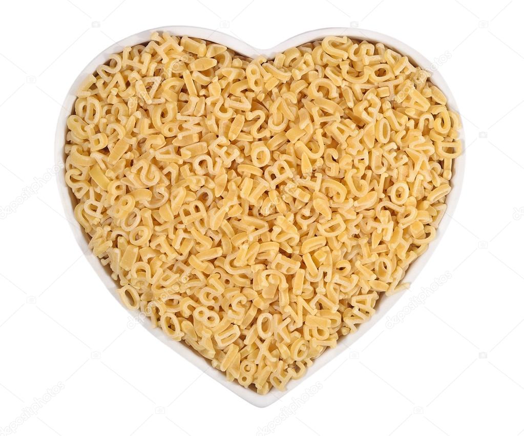 Alphabet pasta in plate in the form of heart on a white 
