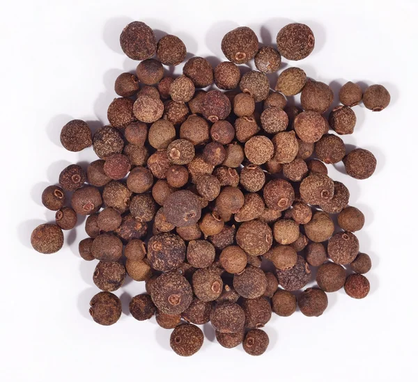 Heap of allspice on a white — Stock Photo, Image