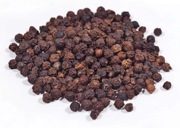 Heap of black pepper on a white — Stock Photo, Image