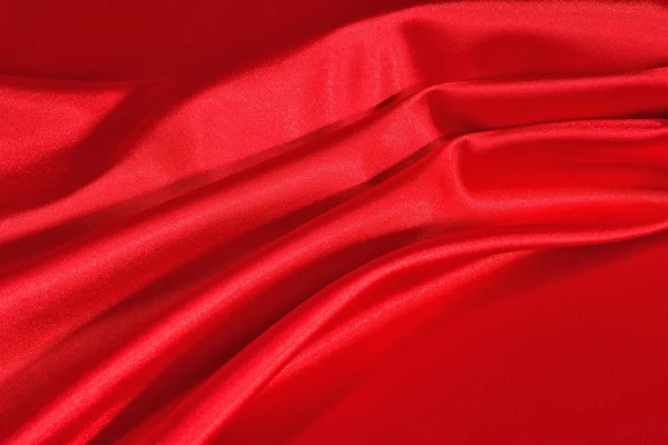 Pozadí z červeného saténu tkaniny — Stock fotografie