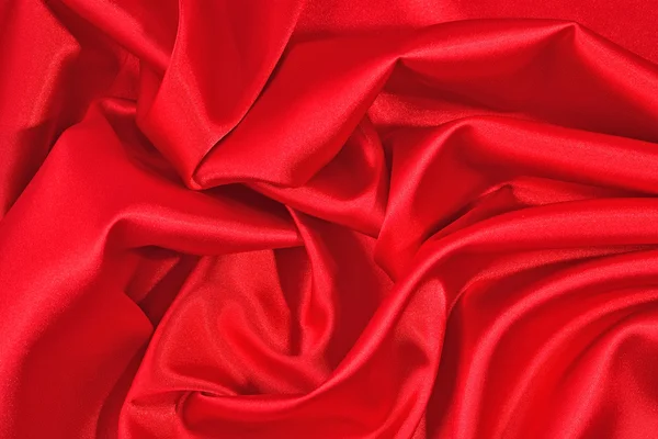 Pozadí z červeného saténu tkaniny — Stock fotografie