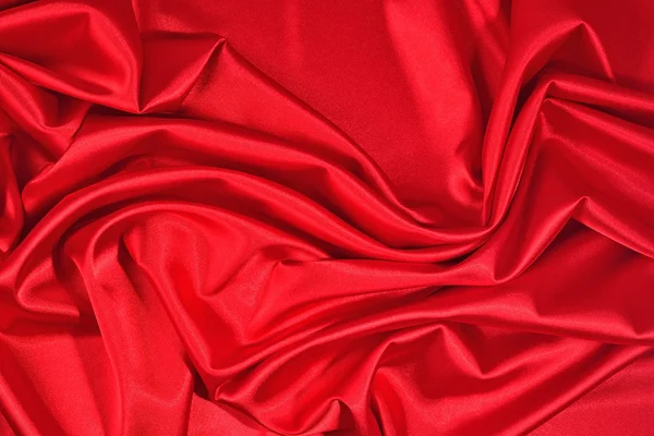 Achtergrond van een rode satijnen stof — Stockfoto