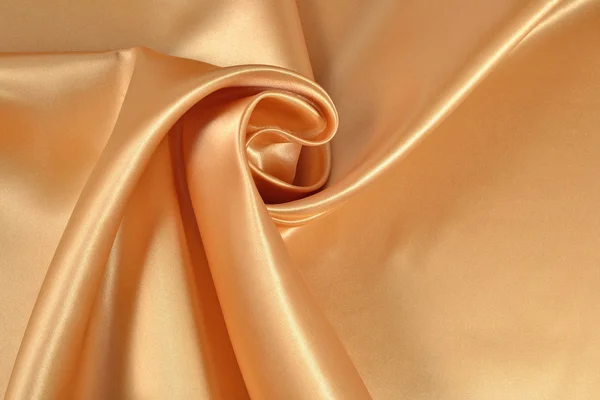Фон из золотой атласной ткани — стоковое фото