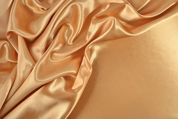 Fond de tissu satiné doré — Photo