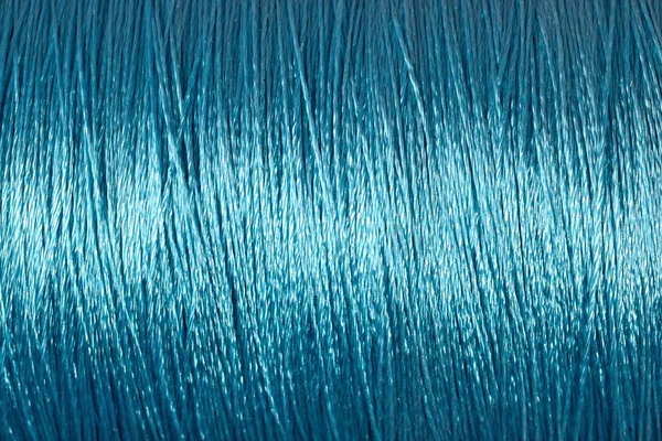 Spole av blå tråd makro bakgrund — Stockfoto