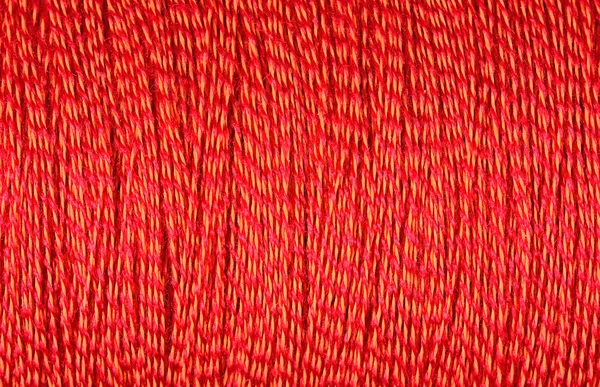 Spool of orange thread macro background — Stock Photo, Image