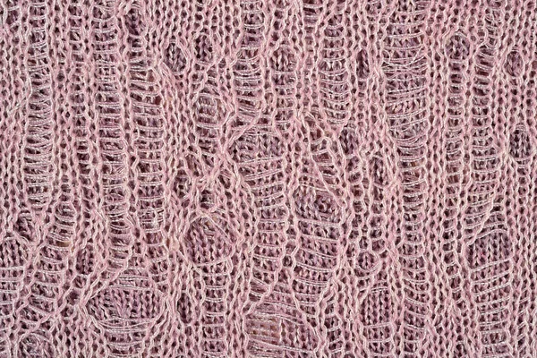 Rózsaszín-szürke áttört melange kötött anyag ruhák varrására háttereként — Stock Fotó