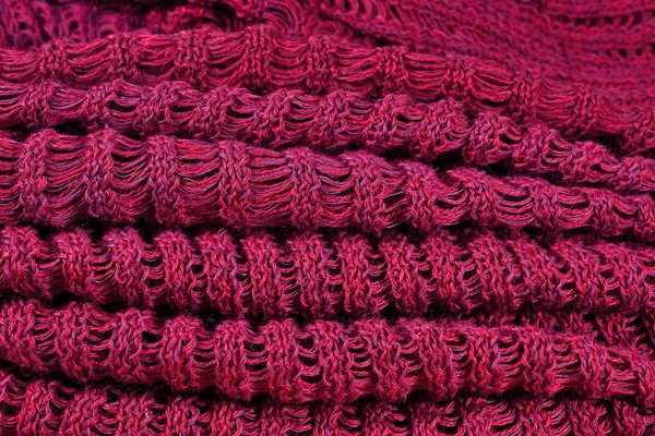 Stack of red melange openwork knitted fabric — Stock Photo, Image