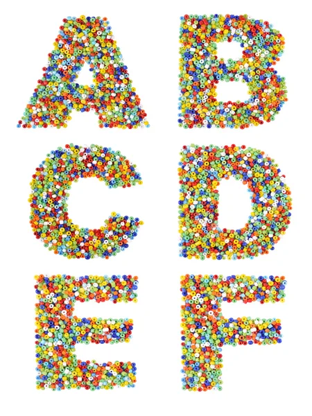 Letters of the alphabet A through F made from colorful glass bea — Stock Photo, Image