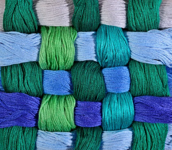 Colorful twisted skeins of floss as background texture — Stock Photo, Image