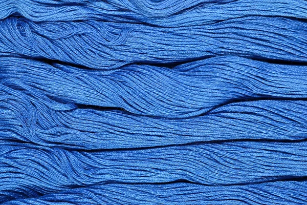 Blue skeins of floss as background texture — Stock Photo, Image