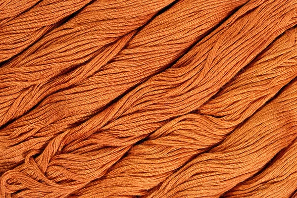 Brown skeins of floss as background texture — Stock Photo, Image
