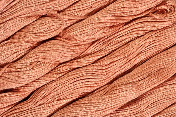 Brown skeins of floss as background texture — Stock Photo, Image