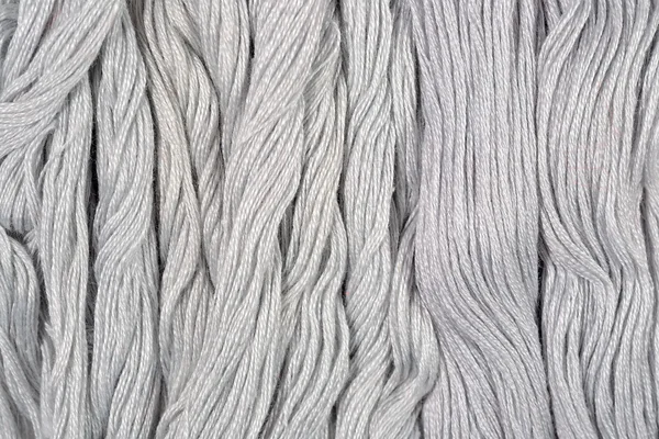 Gray skeins of floss as background texture — Stock Photo, Image
