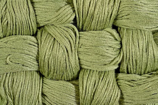 Green twisted skeins of floss as background texture — Stock Photo, Image