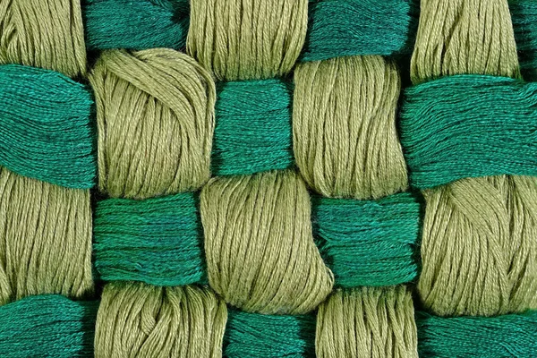 Green twisted skeins of floss as background texture — Stock Photo, Image