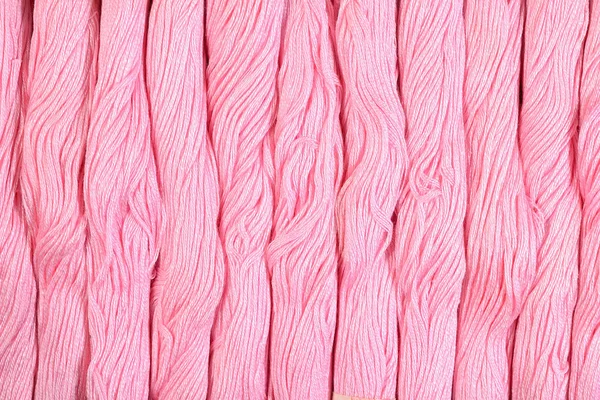 Pink skeins of floss as background texture — Stock Photo, Image