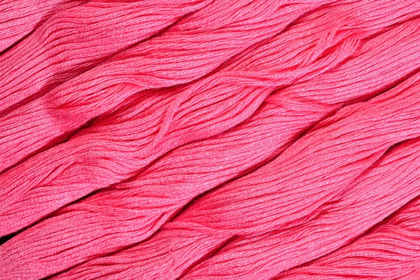 Pink skeins of floss as background texture — Stock Photo, Image