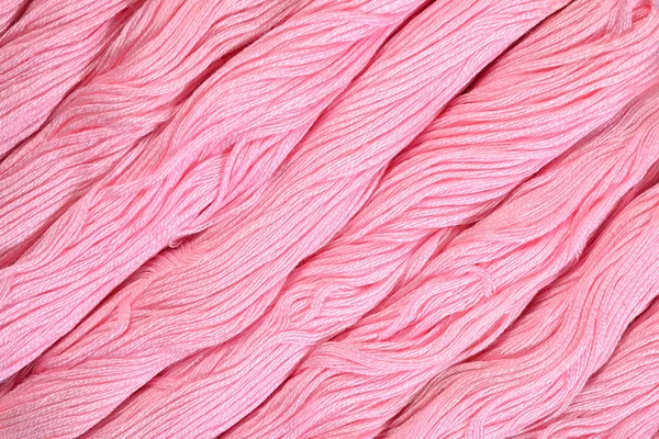 Pink skeins of floss as background texture — Stock Photo, Image