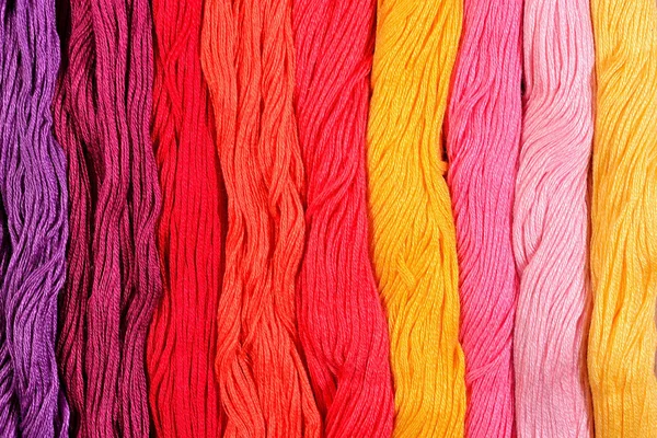 Colorful skeins of floss as background texture — Stock Photo, Image