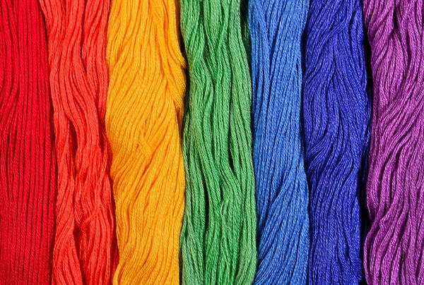 Colorful skeins of floss as background texture — Stock Photo, Image