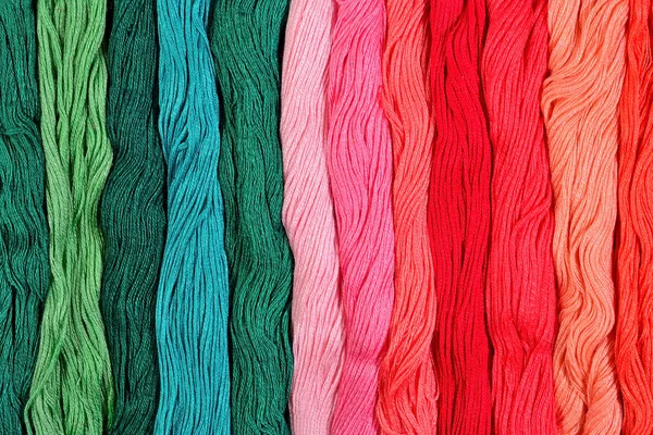 Colorful skeins of floss as background texture — Stock Photo, Image