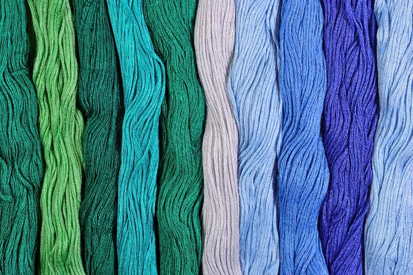 Colorful skeins of floss as background texture — Stock Photo, Image