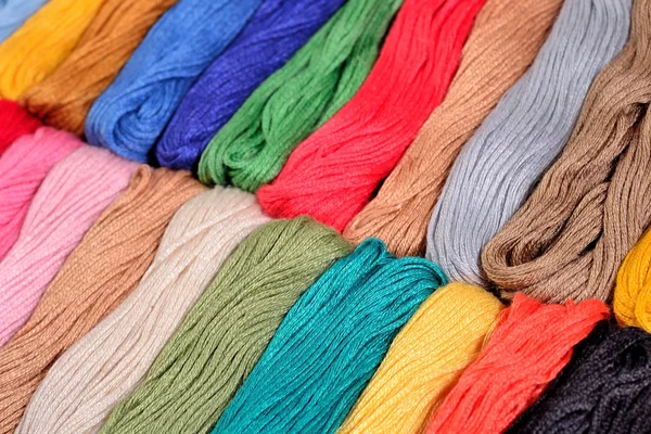 Colorful skeins of floss as background texture — Stock Photo, Image