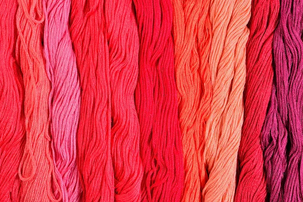 Colorful skeins of floss as background texture — Stock Photo, Image