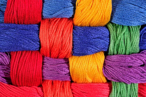 Colorful twisted skeins of floss as background texture — Stock Photo, Image