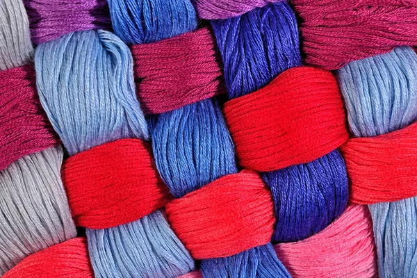 Colorful twisted skeins of floss as background texture — Stock Photo, Image