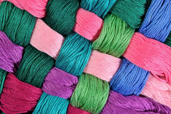 Colorful twisted skeins of floss as background texture — Stock Photo, Image