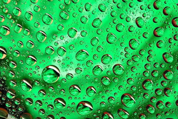 Gotas de agua en la superficie verde —  Fotos de Stock