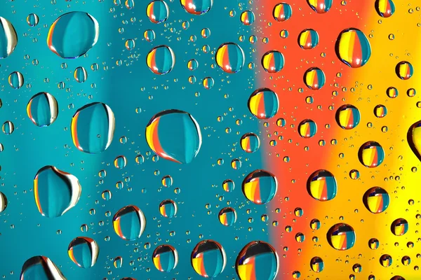 Water drops on multicolor background — Stock Photo, Image