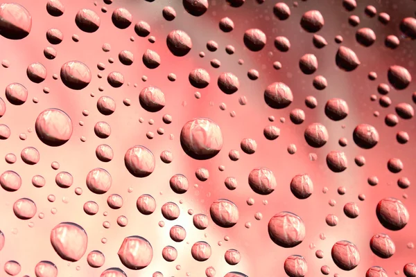 Gotas de agua sobre fondo rosa — Foto de Stock