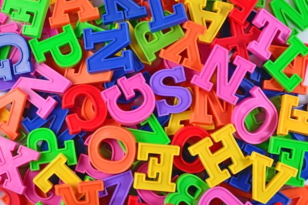 Färgglada plast alfabetet bokstäver som bakgrund — Stockfoto
