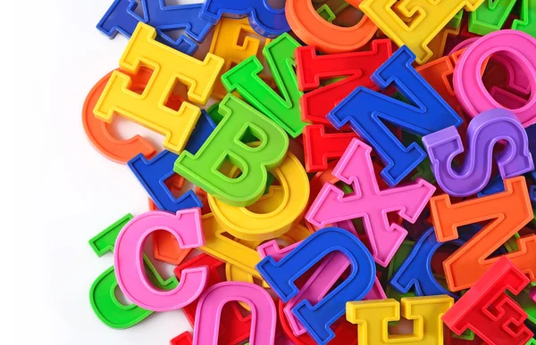 Letras coloridas do alfabeto plástico em um branco — Fotografia de Stock