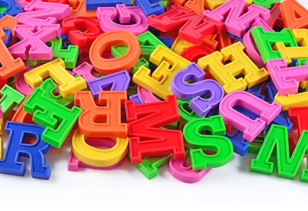 Colorful plastic alphabet letters on a white — Stock Photo, Image