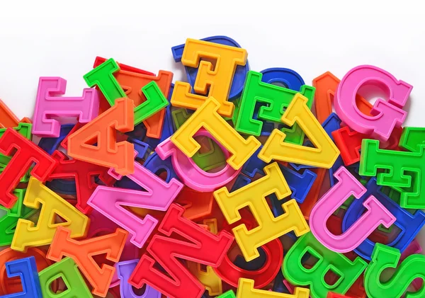 Letras coloridas do alfabeto plástico em um branco — Fotografia de Stock