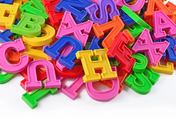 Letras plásticas coloridas del alfabeto en un blanco —  Fotos de Stock