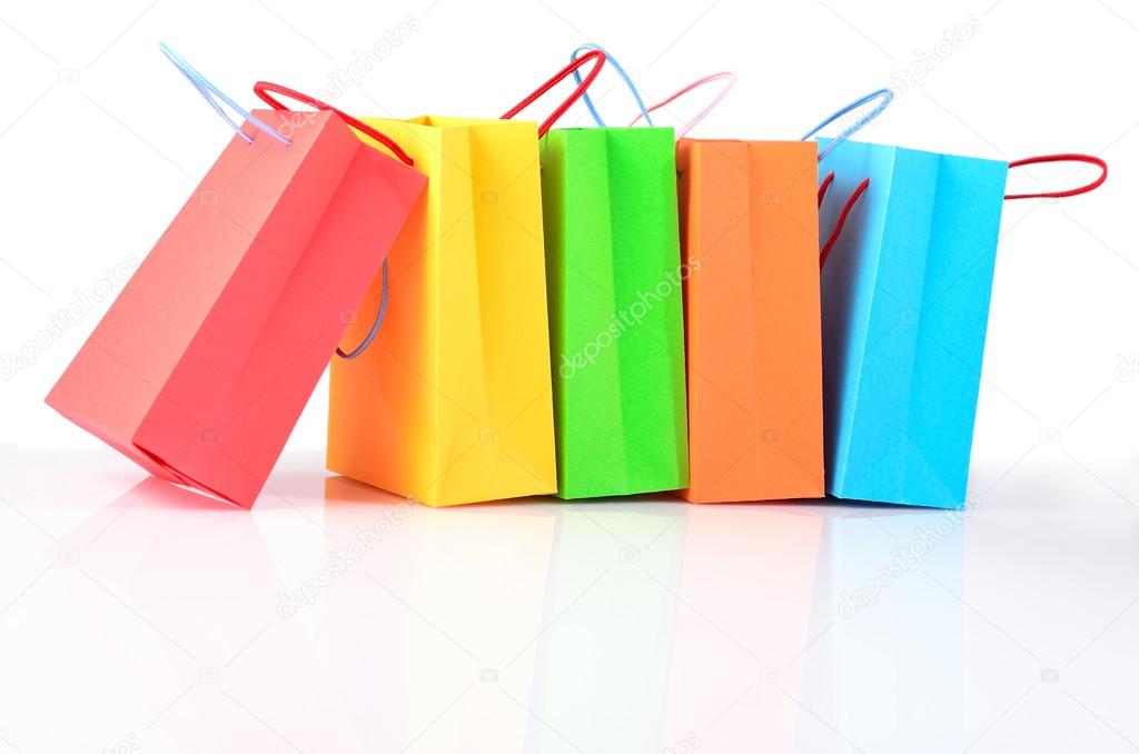 Shopping colorful sale paper bags close-up on a white