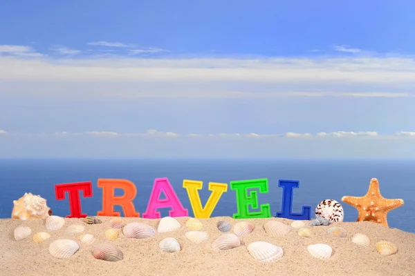 Travel letters on a beach sand — Stock Photo, Image