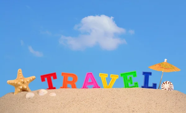Travel letters on a beach sand — Stock Photo, Image