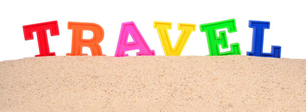 Travel letters on a beach sand on a white background