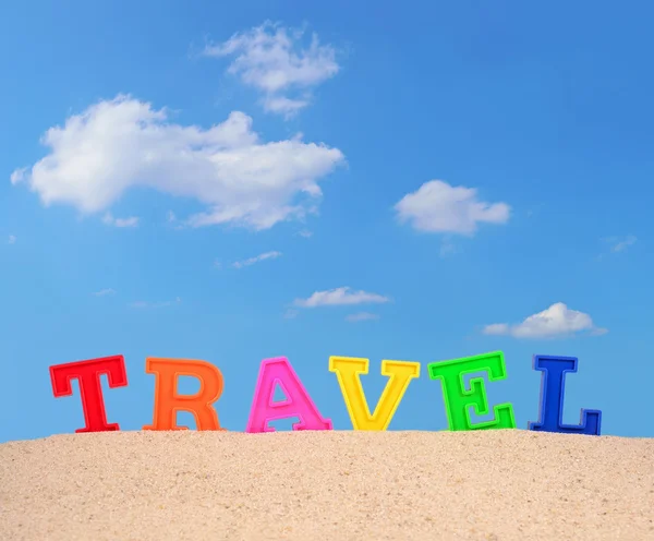 Travel letters on a beach sand — Stock Photo, Image