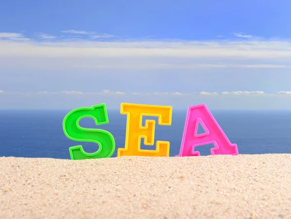 Meer Buchstaben auf einem Strand Sand — Stockfoto