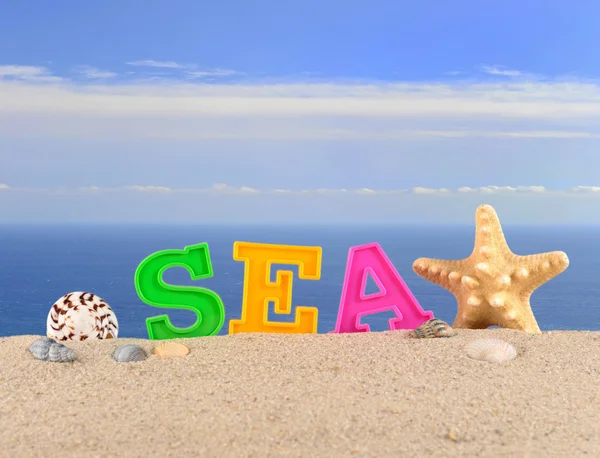 Sea letters on a beach sand — Stock Photo, Image