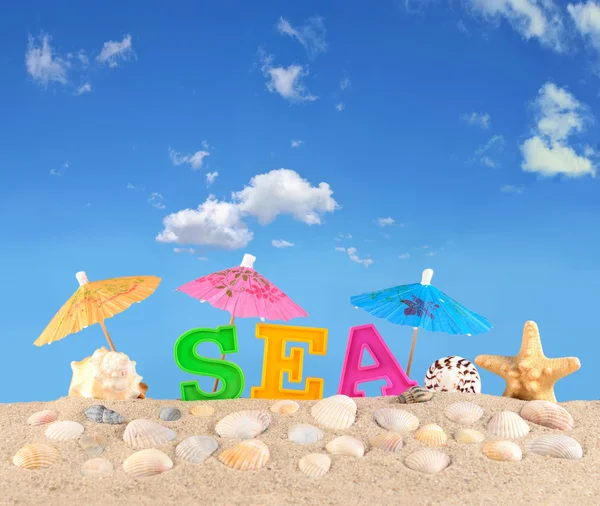Meer Buchstaben auf einem Strand Sand — Stockfoto