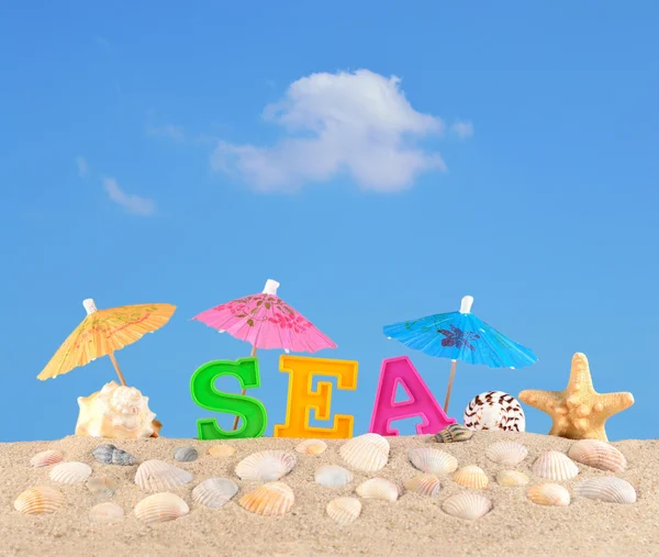 Meer Buchstaben auf einem Strand Sand — Stockfoto